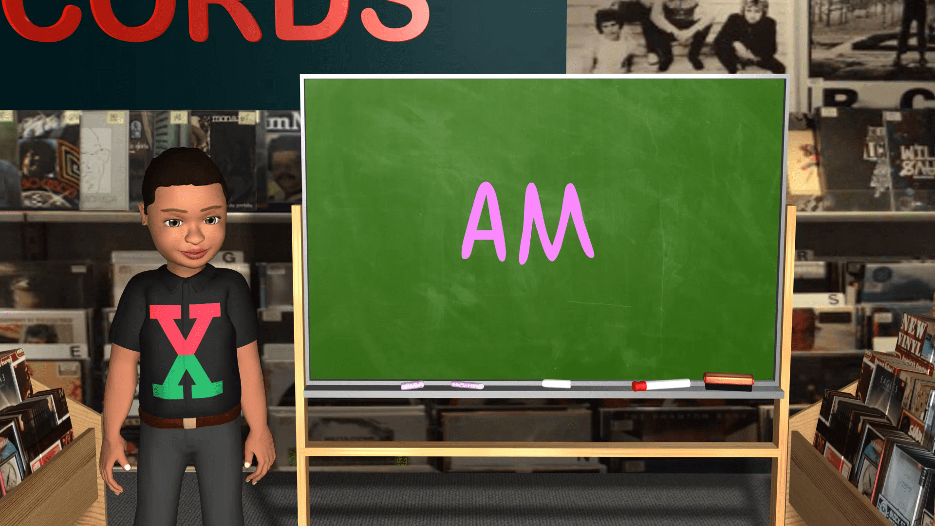 A boy standing in front of a chalkboard with the word am on it.