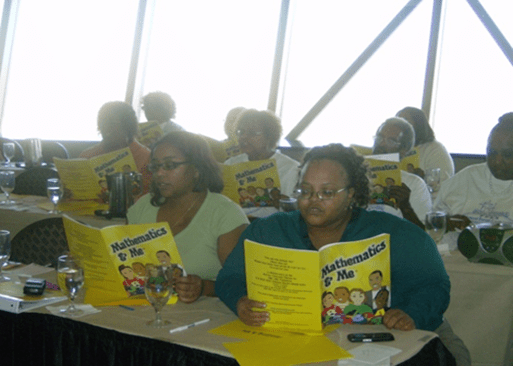 A man wearing a red jacket and gray beanie looks out over a lake and rocky shore.